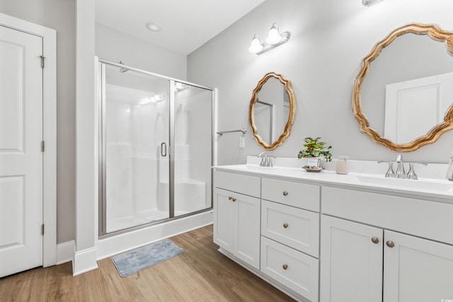 bathroom with vanity, walk in shower, and hardwood / wood-style floors