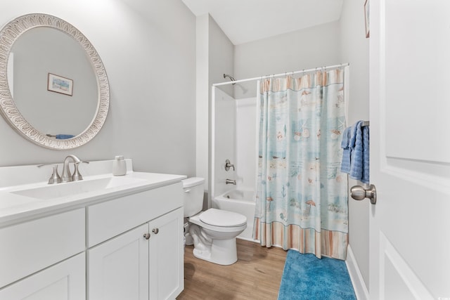 full bathroom with vanity, toilet, hardwood / wood-style flooring, and shower / tub combo with curtain