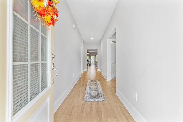 corridor with light hardwood / wood-style flooring