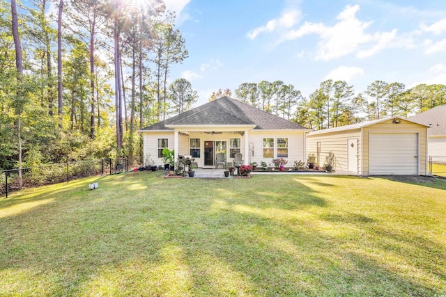 view of front of property with an outdoor structure, a garage, and a front lawn