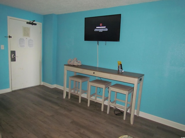 interior space featuring dark hardwood / wood-style flooring and a textured ceiling