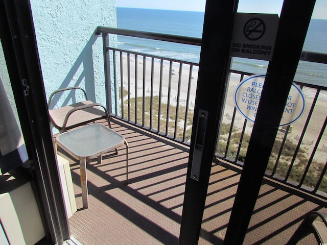 balcony with a beach view and a water view