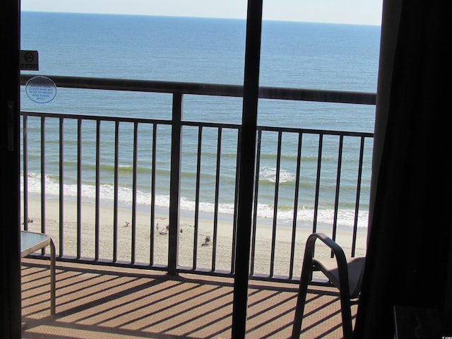 balcony with a beach view and a water view