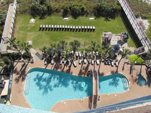 view of swimming pool with a lawn and a patio area