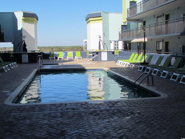 view of swimming pool featuring a patio area