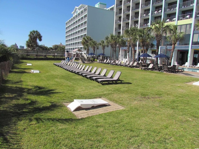 view of community featuring a swimming pool and a yard