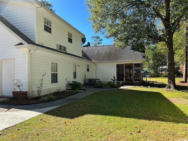 rear view of property with a yard and cooling unit