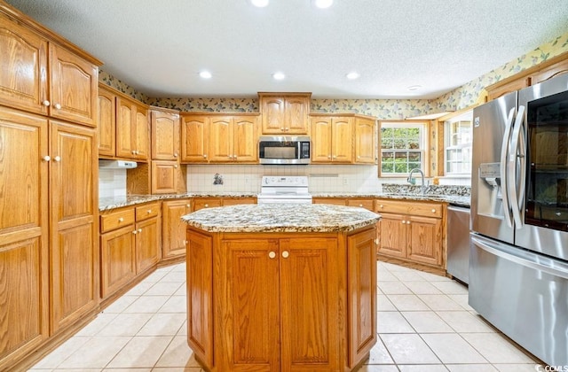244 George Washington Trl, Georgetown, SC 29440 - kitchen featuring stainless steel appliances, a center island, light stone countertops, a sink, and recessed lighting