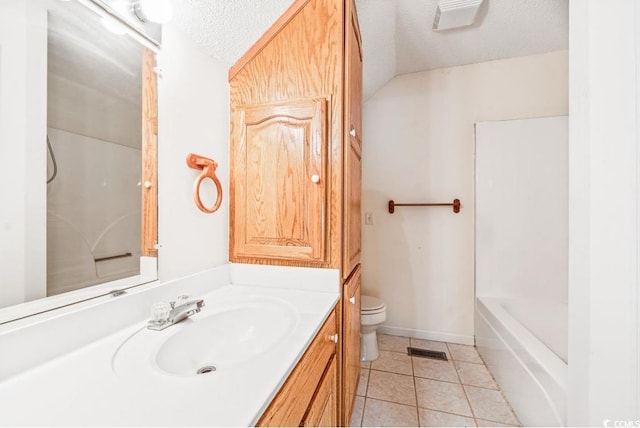 244 George Washington Trl, Georgetown, SC 29440 - bathroom with toilet, vanity, tile patterned floors, a textured ceiling, and a tub to relax in