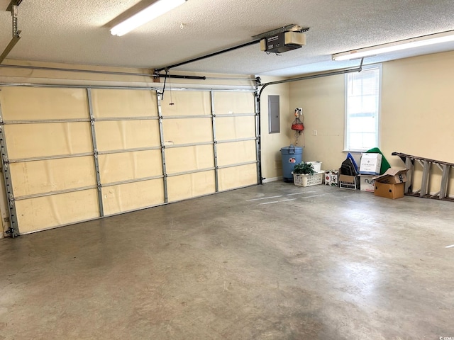 garage with a garage door opener and electric panel