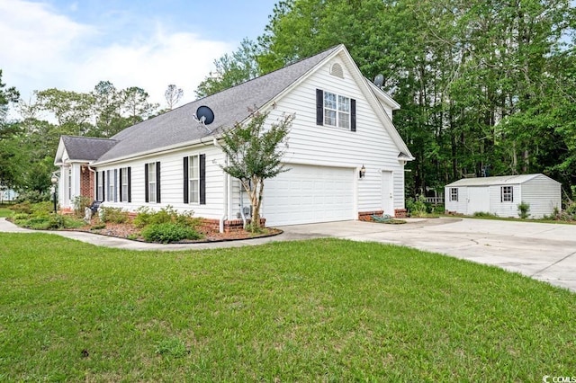 244 George Washington Trl, Georgetown, SC 29440 - view of front of home featuring concrete driveway, a front lawn, an attached garage, an outbuilding, and roof with shingles