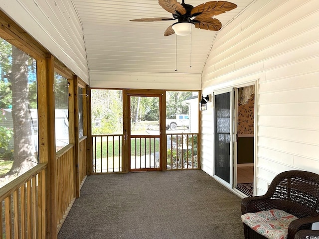 sunroom / solarium featuring ceiling fan, a healthy amount of sunlight, and vaulted ceiling