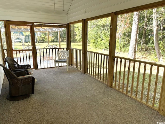 sunroom / solarium featuring vaulted ceiling