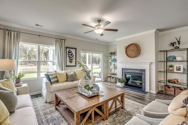 living room featuring ornamental molding, a fireplace, dark hardwood / wood-style floors, and ceiling fan