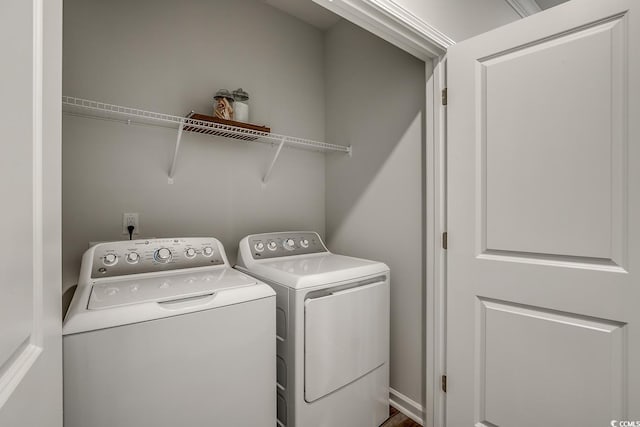 clothes washing area featuring independent washer and dryer