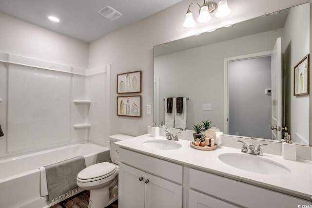 full bathroom with vanity, shower / tub combination, and toilet