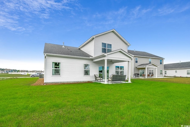 back of house featuring a patio and a yard