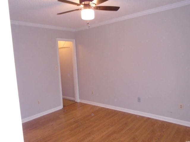 spare room featuring crown molding, hardwood / wood-style floors, and ceiling fan