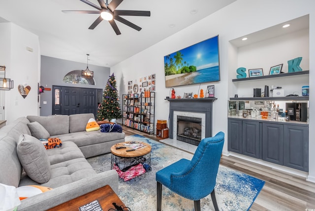 living room with light wood-type flooring and ceiling fan