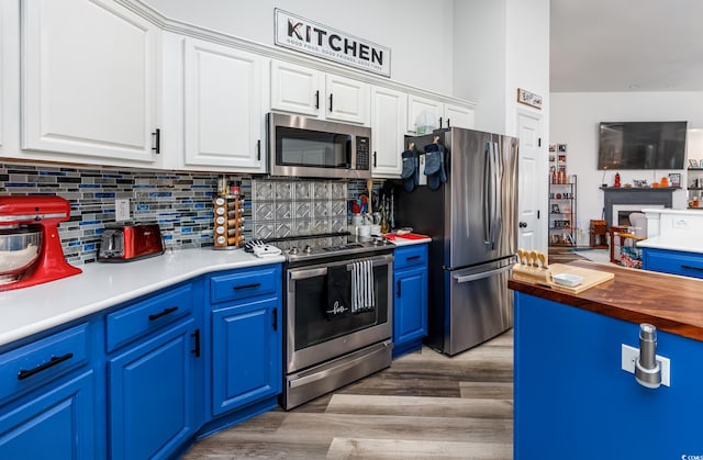 kitchen featuring white cabinetry, light hardwood / wood-style floors, stainless steel appliances, and blue cabinets