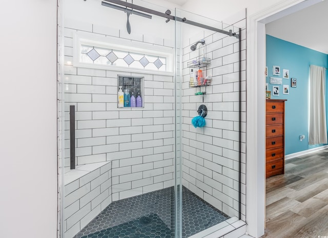 bathroom featuring hardwood / wood-style flooring and walk in shower