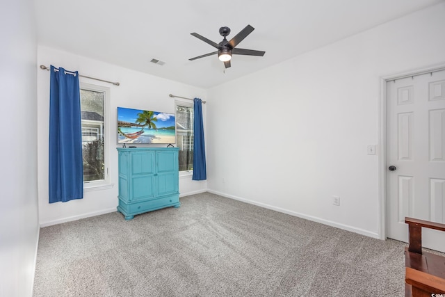 interior space featuring ceiling fan and carpet flooring