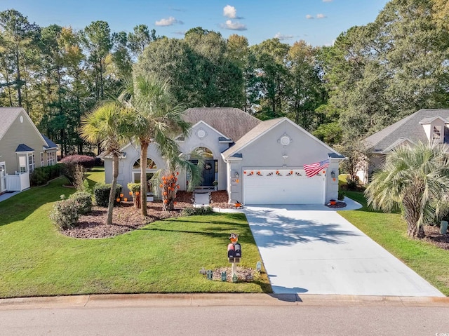 view of front of home with a front yard and a garage