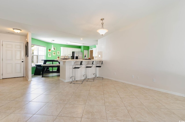 419 Mckendree Ln, Myrtle Beach, SC 29579 - kitchen featuring a peninsula, stainless steel refrigerator with ice dispenser, light tile patterned floors, and light countertops