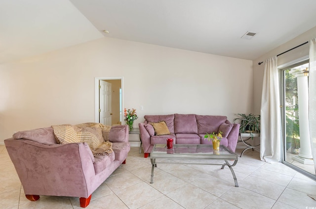 tiled living room featuring vaulted ceiling