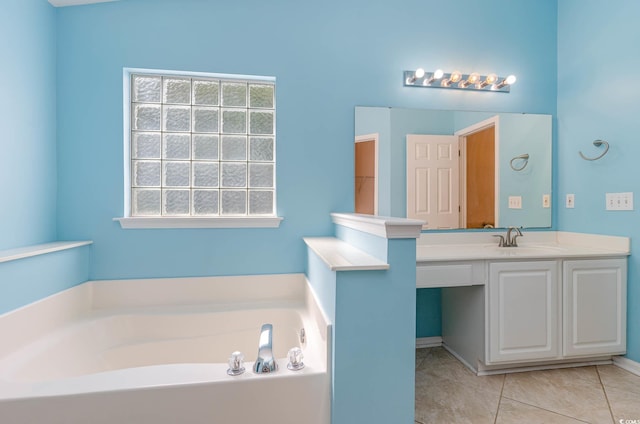 bathroom featuring a washtub, vanity, and tile patterned flooring