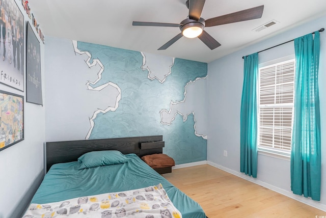 bedroom featuring hardwood / wood-style floors and ceiling fan