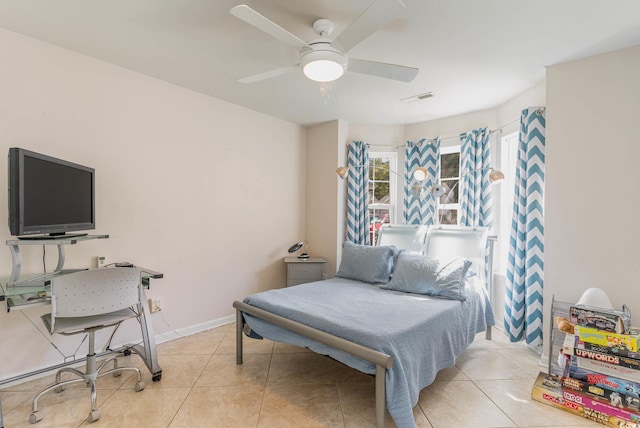 bedroom with ceiling fan and light tile patterned floors