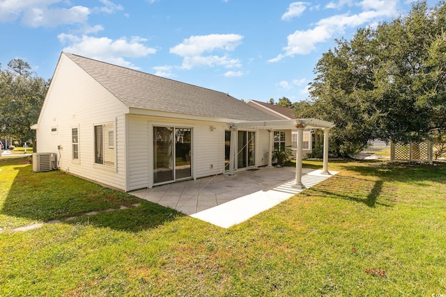 back of property with a patio, a pergola, central AC, and a lawn