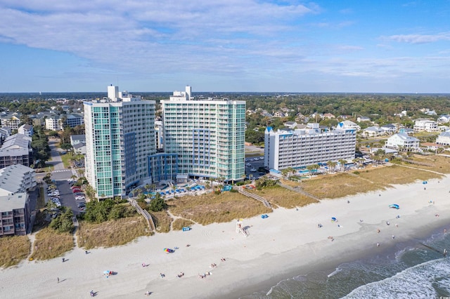 bird's eye view featuring a water view and a beach view