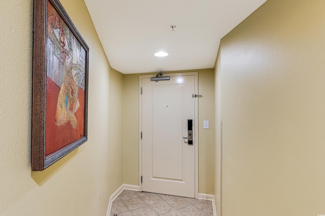 doorway to outside with light tile patterned floors