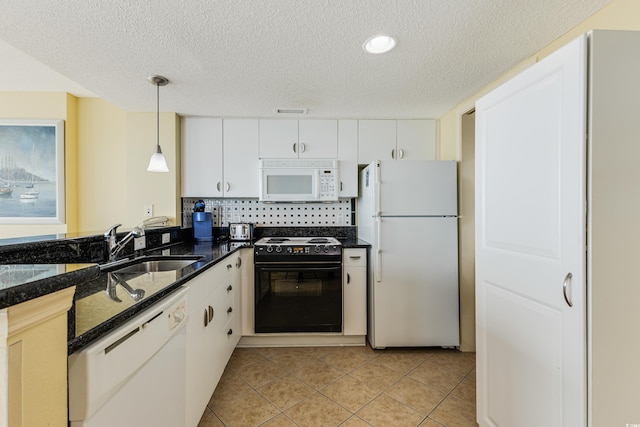 kitchen with sink, white cabinets, hanging light fixtures, and white appliances