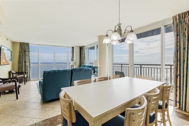 tiled dining room with a water view, a wealth of natural light, an inviting chandelier, and a wall of windows