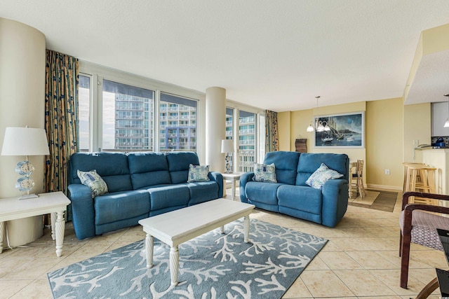 living room featuring a textured ceiling, a chandelier, and light tile patterned floors