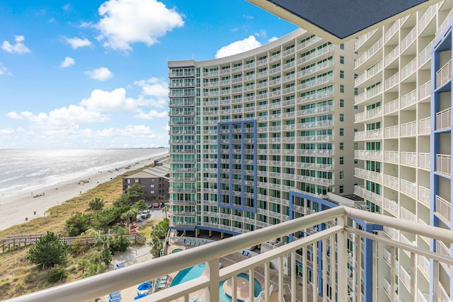 balcony featuring a water view and a beach view