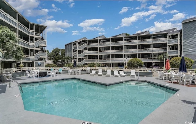 community pool with a patio area