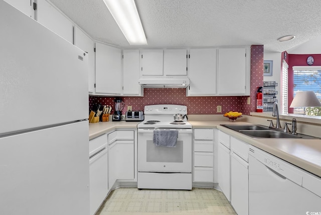 kitchen with sink, white cabinets, a textured ceiling, and white appliances