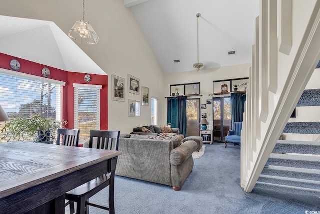 carpeted living room featuring high vaulted ceiling and ceiling fan