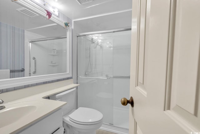 bathroom with vanity, toilet, and an enclosed shower