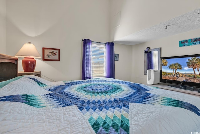 bedroom featuring a textured ceiling and multiple windows