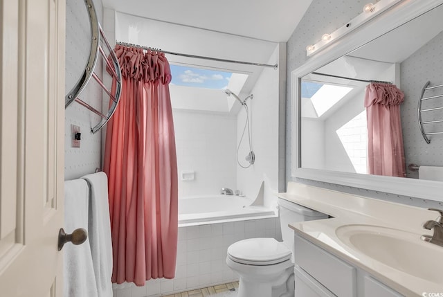 full bathroom with shower / bath combination with curtain, toilet, vaulted ceiling with skylight, vanity, and tile patterned flooring