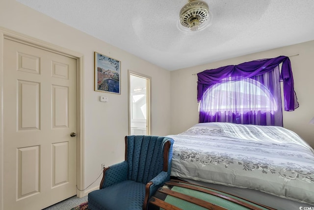 carpeted bedroom with a textured ceiling