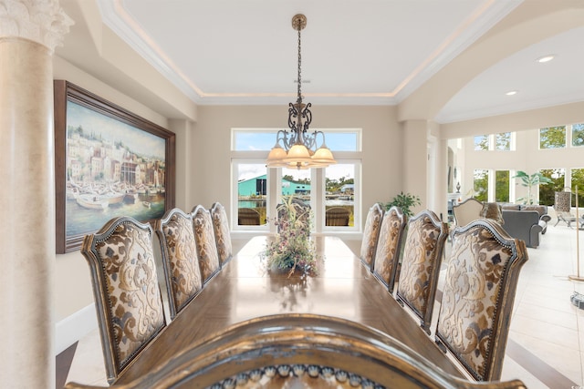 dining area featuring light tile patterned flooring, ornate columns, and plenty of natural light