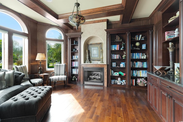 living area with ornamental molding, beam ceiling, coffered ceiling, and dark wood-type flooring