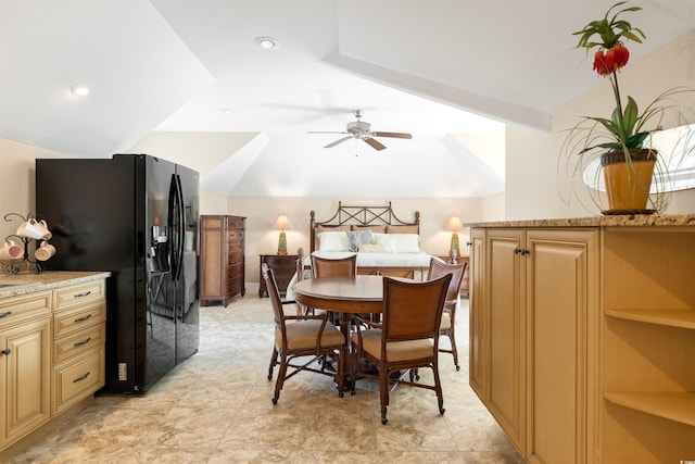 dining space with ceiling fan and vaulted ceiling