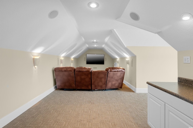 home theater with light carpet and lofted ceiling